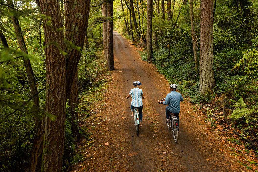 Follow quiet, tree-lined paths along the Galloping Goose Trail. Photo: The Pedaler Bicycle Tours