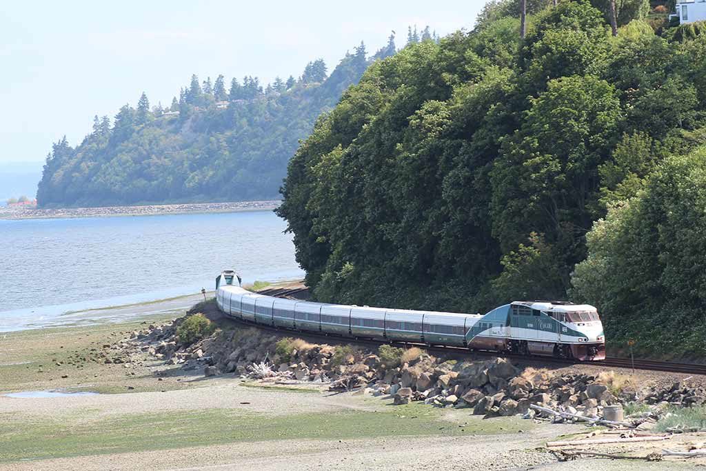 Wind your way past forests and rivers on the way to Vancouver. Credit: Amtrak Cascades